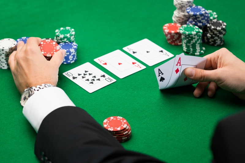 10876516-poker-player-with-cards-and-chips-at-casino